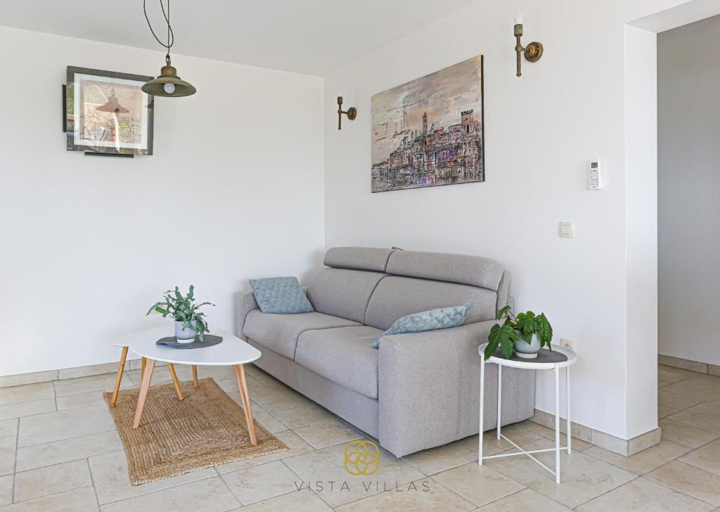 Living room with sofa and coastal artwork at Salty Kisses, Villa S