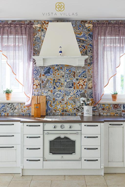 Kitchen with colourful tile detail in Salty Kisses, Villa S