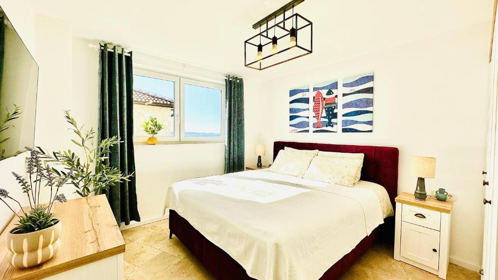 Bedroom with a sea-view window and fish artwork in Endless Summer