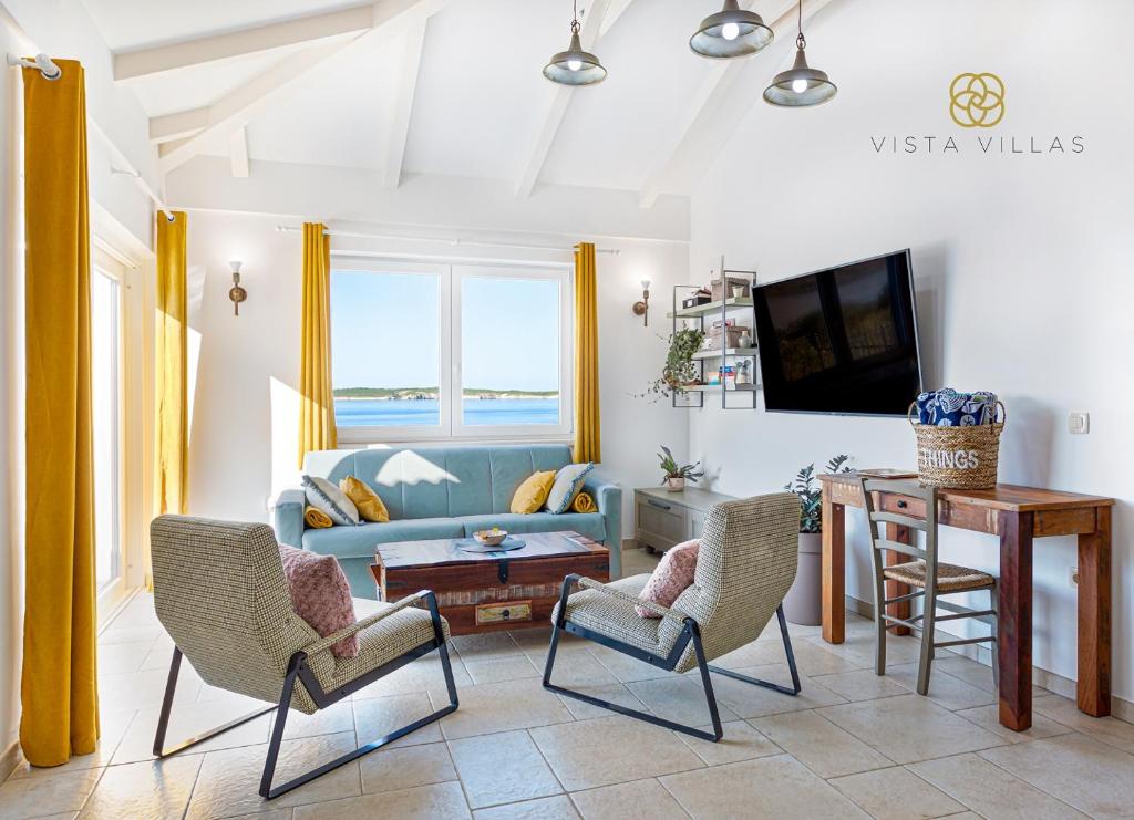 Bright living room with yellow curtains and a sea-view window at Sweet Life