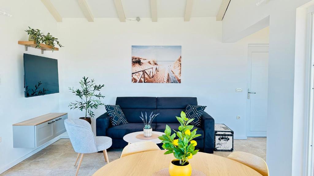 Living room with navy sofa and wall TV in Lovers Nest