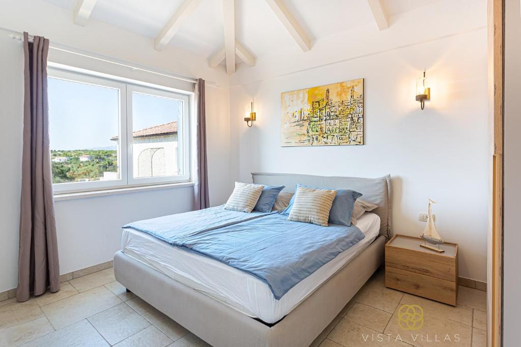 Bedroom with blue bedding and a garden-view window at Sweet Life