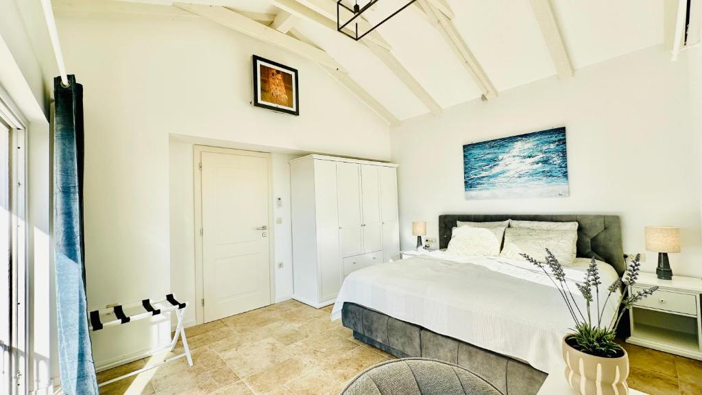 Bedroom with white wardrobe and sea artwork in Lovers Nest