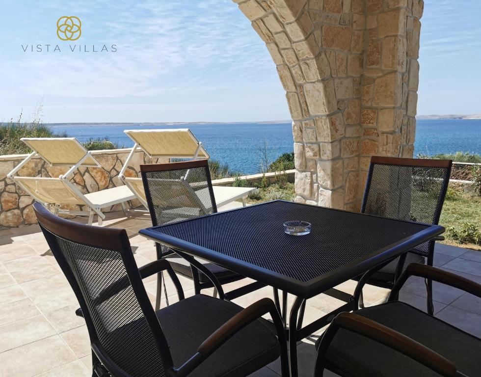 Outdoor dining area overlooking the sea at Salty Kisses, Villa S