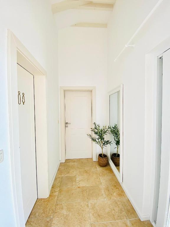 Bright hallway with mirror and travertine floor in Lovers Nest